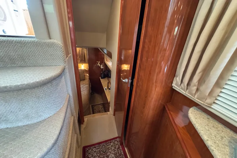Slide: The Image of Interior of 2004 Sea Ray 390 Motor Yacht with carpeted stairs and wooden finishes. - 27