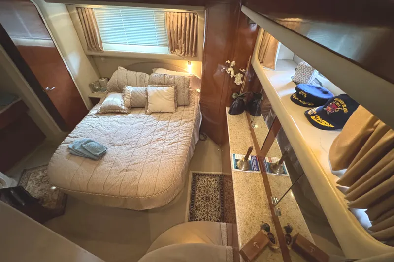 Slide: The Image of Luxurious bedroom interior of 2004 Sea Ray 390 Motor Yacht with cozy bed and elegant decor. - 28