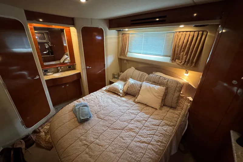 Slide: The Image of Luxurious bedroom interior of 2004 Sea Ray 390 Motor Yacht with cozy bedding. - 29