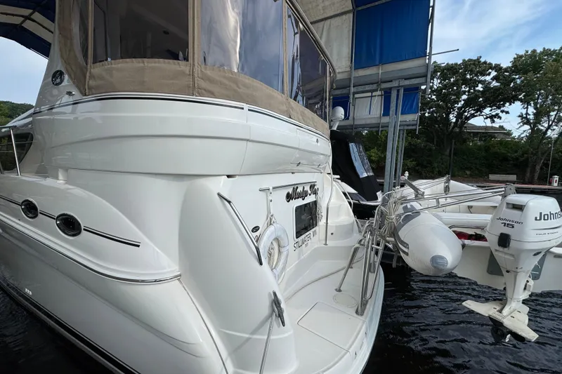 Slide: The Image of 2004 Sea Ray 390 Motor Yacht docked with inflatable boat and Johnson outboard motor. - 3