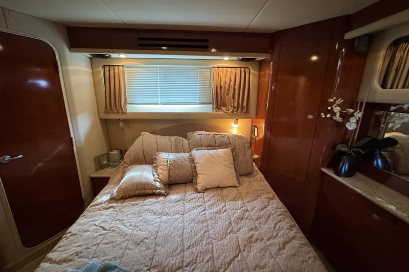 Slide: The Image of Luxurious bedroom interior of 2004 Sea Ray 390 Motor Yacht with elegant wood finishes. - 30
