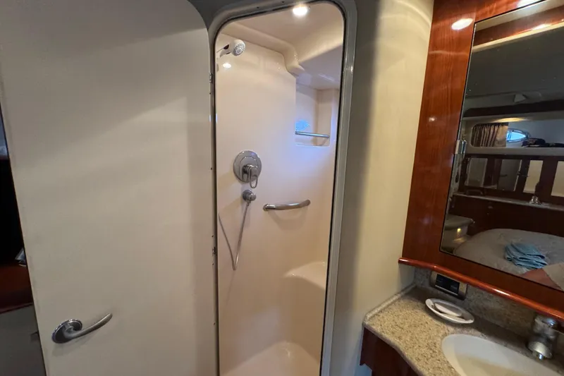 Slide: The Image of Shower area in 2004 Sea Ray 390 Motor Yacht with modern fixtures and wooden cabinetry. - 32