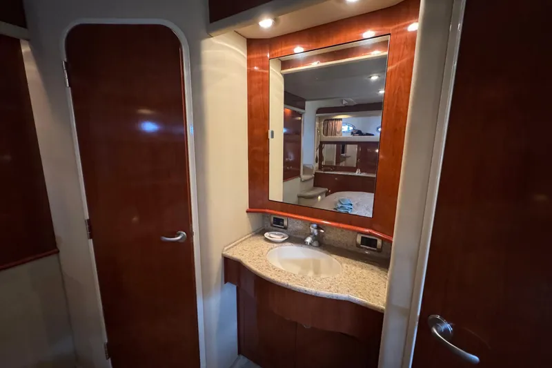 Slide: The Image of 2004 Sea Ray 390 Motor Yacht bathroom with wood cabinetry and mirror. - 33