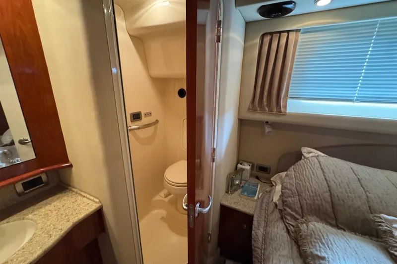 Slide: The Image of 2004 Sea Ray 390 Motor Yacht interior with bathroom and cozy bedroom. - 34