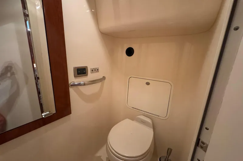 Slide: The Image of Bathroom interior of 2004 Sea Ray 390 Motor Yacht, featuring toilet and mirror. - 35