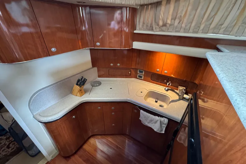 Slide: The Image of Luxurious kitchen area in a 2004 Sea Ray 390 Motor Yacht with wood cabinetry. - 36