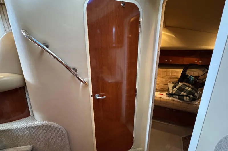 Slide: The Image of Interior of 2004 Sea Ray 390 Motor Yacht, featuring cabin door and cozy sleeping area. - 38