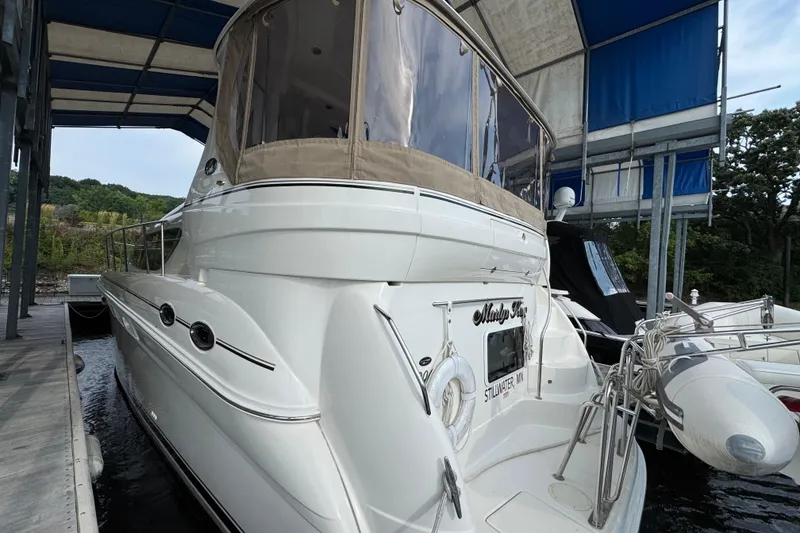 Slide: The Image of 2004 Sea Ray 390 Motor Yacht docked under a canopy. - 4