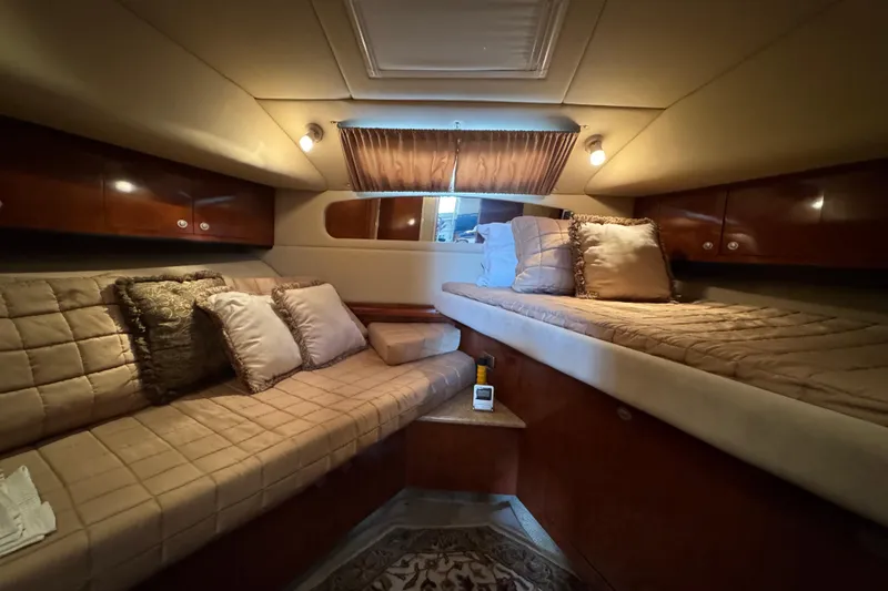 Slide: The Image of Luxurious 2004 Sea Ray 390 Motor Yacht cabin with cozy bedding and elegant lighting. - 42