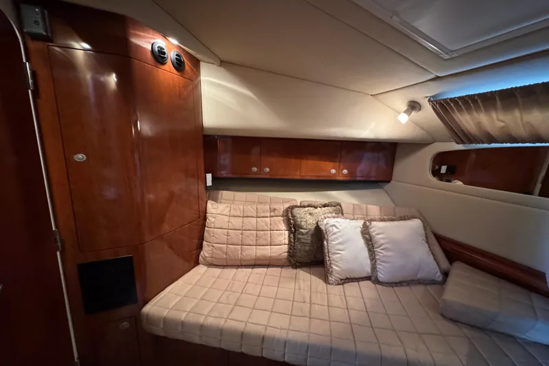 Slide: The Image of Luxurious cabin interior of 2004 Sea Ray 390 Motor Yacht with plush bedding and wood finish. - 44