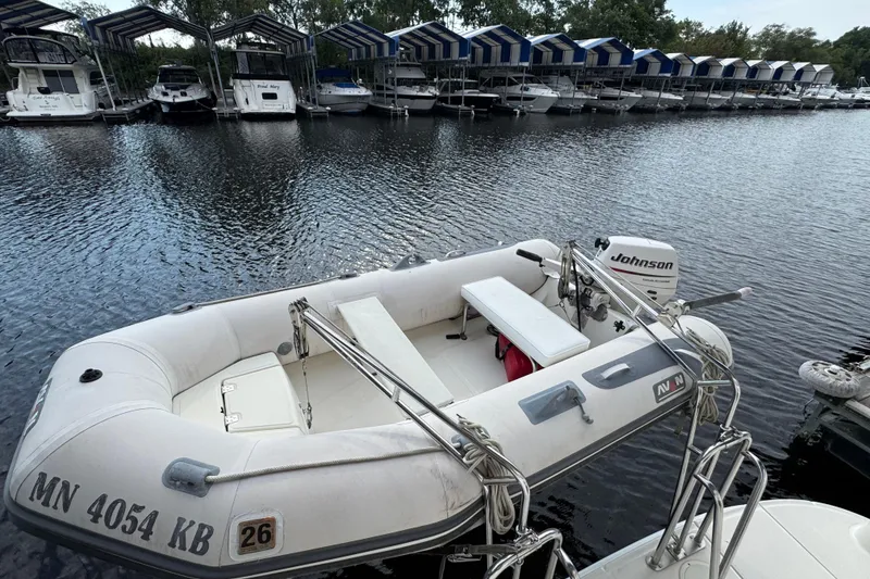 Slide: The Image of Inflatable boat with Johnson motor docked near Sea Ray 390 Motor Yacht, 2004 model. - 6