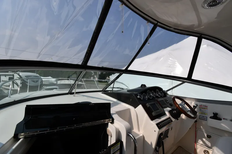 Slide: The Image of Interior view of 2011 Sea Ray 310 Sundancer boat cockpit with steering wheel and dashboard. - 10