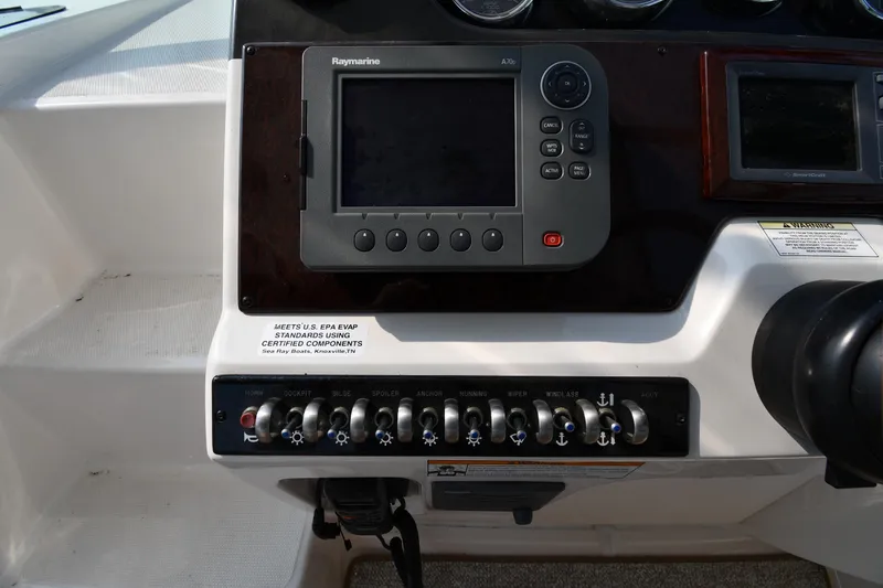 Slide: The Image of Control panel of 2011 Sea Ray 310 Sundancer with Raymarine display and switches. - 13