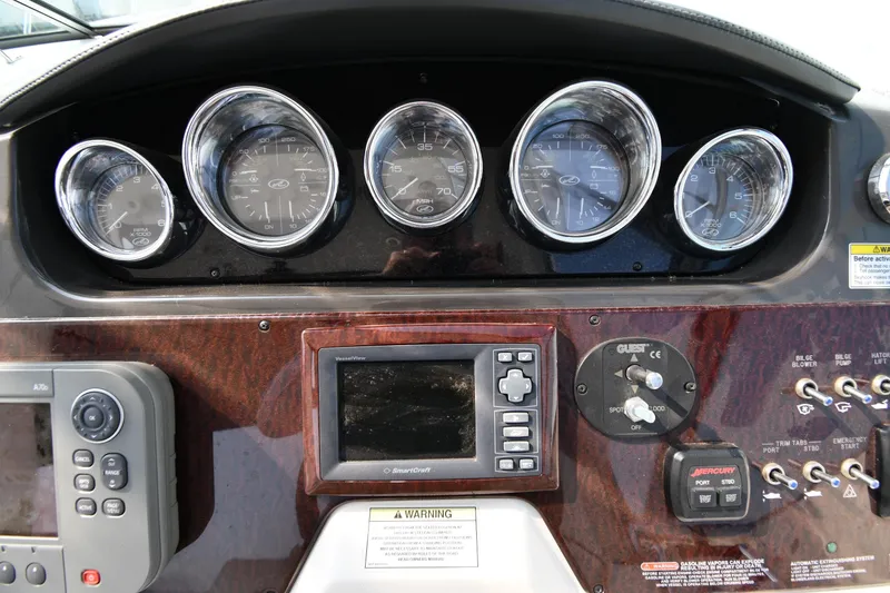 Slide: The Image of Dashboard of a 2011 Sea Ray 310 Sundancer boat with gauges and controls. - 14
