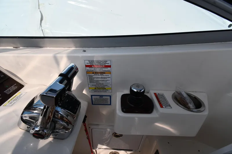 Slide: The Image of Control panel of 2011 Sea Ray 310 Sundancer boat with throttle and warning labels. - 15