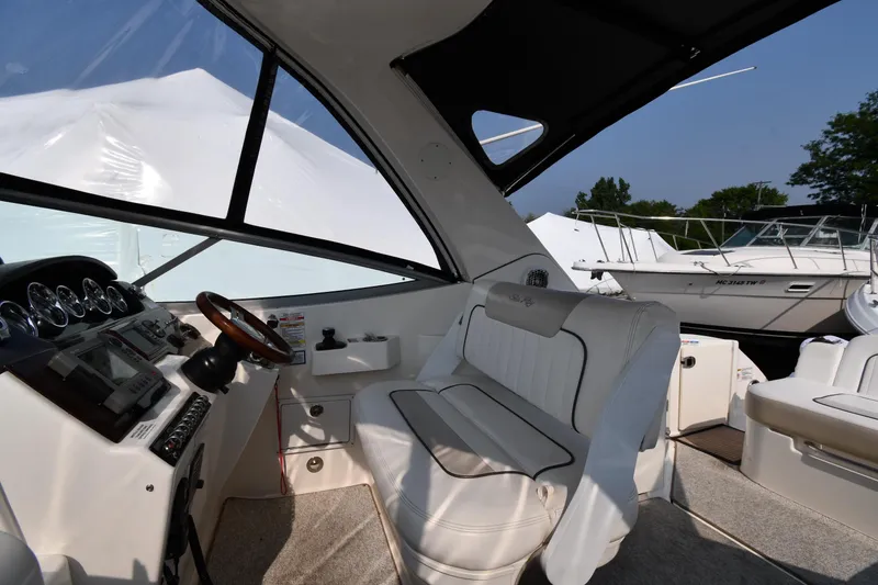 Slide: The Image of Interior of 2011 Sea Ray 310 Sundancer boat with helm and seating area. - 16