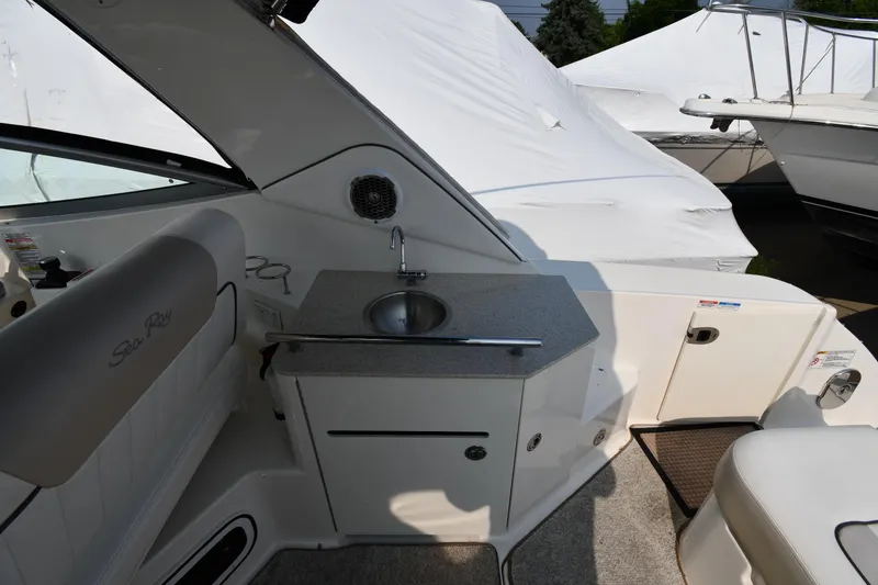 Slide: The Image of Interior view of 2011 Sea Ray 310 Sundancer boat with sink and seating area. - 24