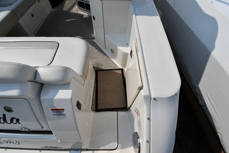 Slide: The Image of 2011 Sea Ray 310 Sundancer boat interior with seating and storage area. - 26