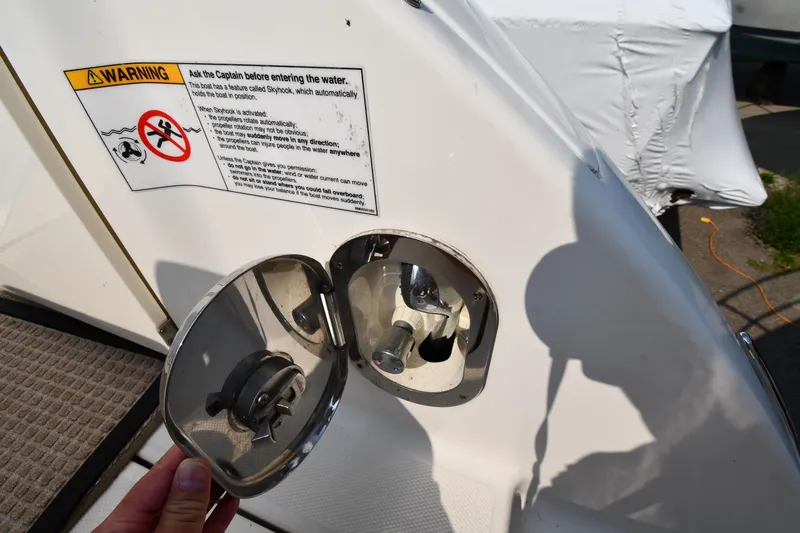 Slide: The Image of 2011 Sea Ray 310 Sundancer boat fuel cap with warning label and shadow. - 27