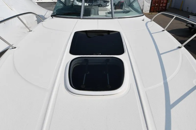 Slide: The Image of 2011 Sea Ray 310 Sundancer boat deck with hatch windows and railings. - 33