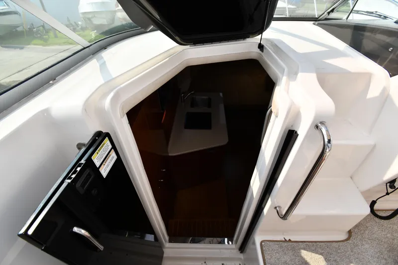 Slide: The Image of 2011 Sea Ray 310 Sundancer cabin entrance with open hatch and visible interior. - 35