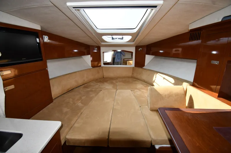 Slide: The Image of Luxurious interior of 2011 Sea Ray 310 Sundancer with plush seating and skylight. - 36