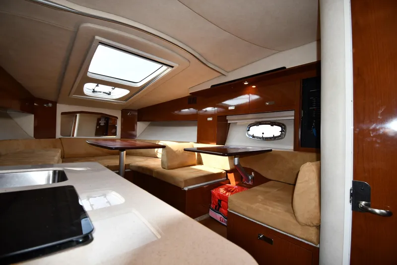 Slide: The Image of Interior of 2011 Sea Ray 310 Sundancer yacht with seating and table. - 37