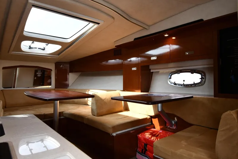Slide: The Image of Interior of 2011 Sea Ray 310 Sundancer yacht with seating and wooden cabinetry. - 38