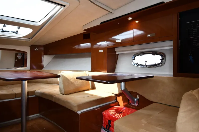 Slide: The Image of Interior of 2011 Sea Ray 310 Sundancer yacht with seating and wooden cabinetry. - 44