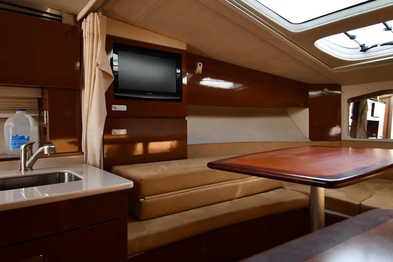 Slide: The Image of Interior of 2011 Sea Ray 310 Sundancer yacht with seating, table, and TV. - 46