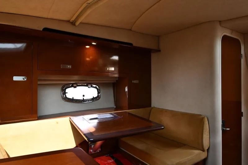 Slide: The Image of Interior of 2011 Sea Ray 310 Sundancer with wood cabinetry and seating area. - 49