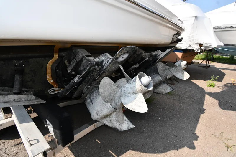 Slide: The Image of 2011 Sea Ray 310 Sundancer boat propellers on a trailer, close-up view. - 5