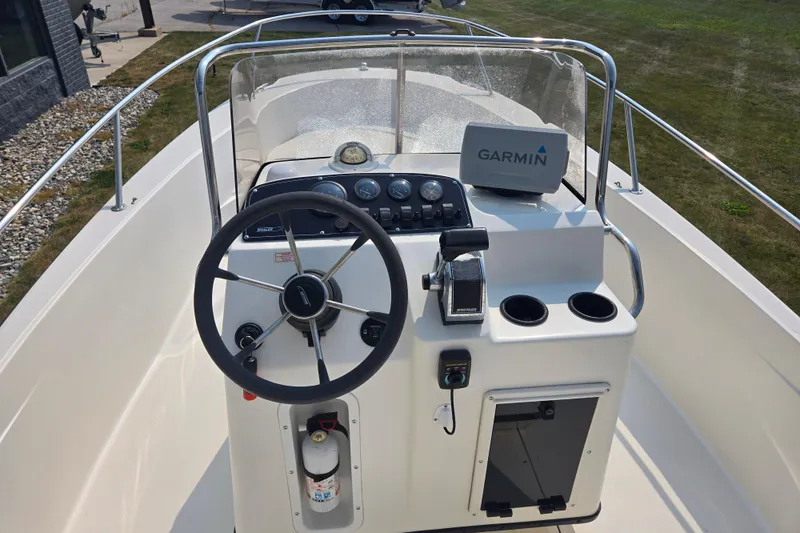 Slide: The Image of 1998 Boston Whaler 18 Dauntless boat console with Garmin GPS and steering wheel. - 10