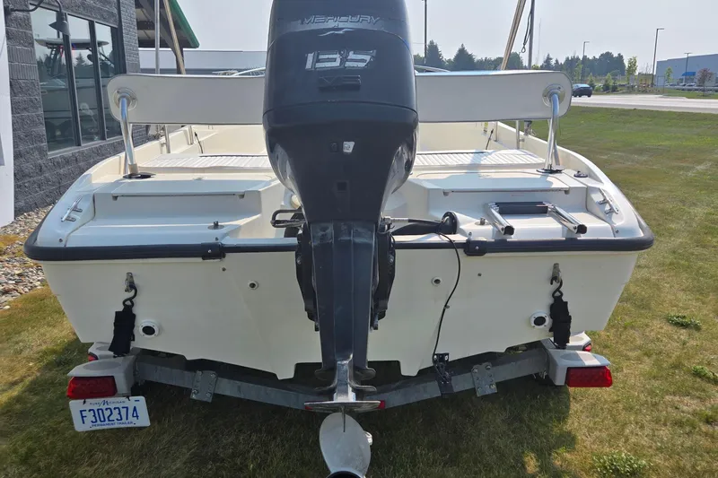 Slide: The Image of 1998 Boston Whaler 18 Dauntless boat with Mercury 135 engine, parked on trailer. - 4