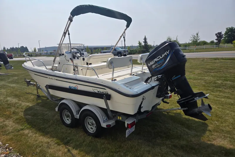 Slide: The Image of 1998 Boston Whaler 18 Dauntless boat with Mercury outboard motor on trailer. - 6