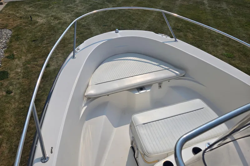 Slide: The Image of 1998 Boston Whaler 18 Dauntless boat interior with white seating and railings. - 9