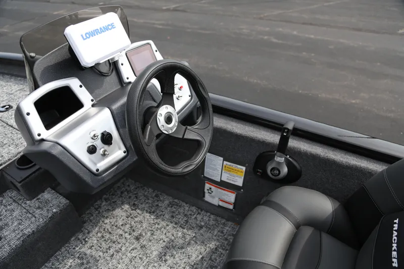 Slide: The Image of 2026 Tracker Pro Team 175 boat dashboard with steering wheel and Lowrance display. - 4