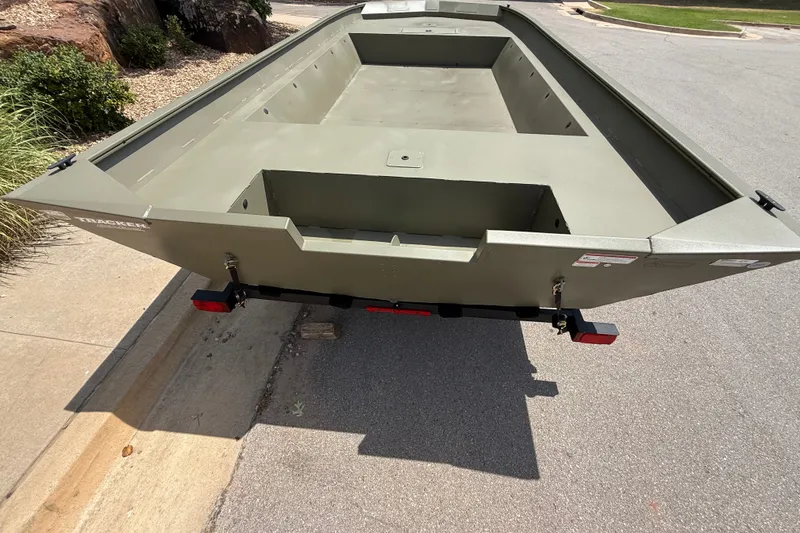 Slide: The Image of 2026 Tracker Grizzly 2072 Utility boat on trailer, parked on a street. - 7