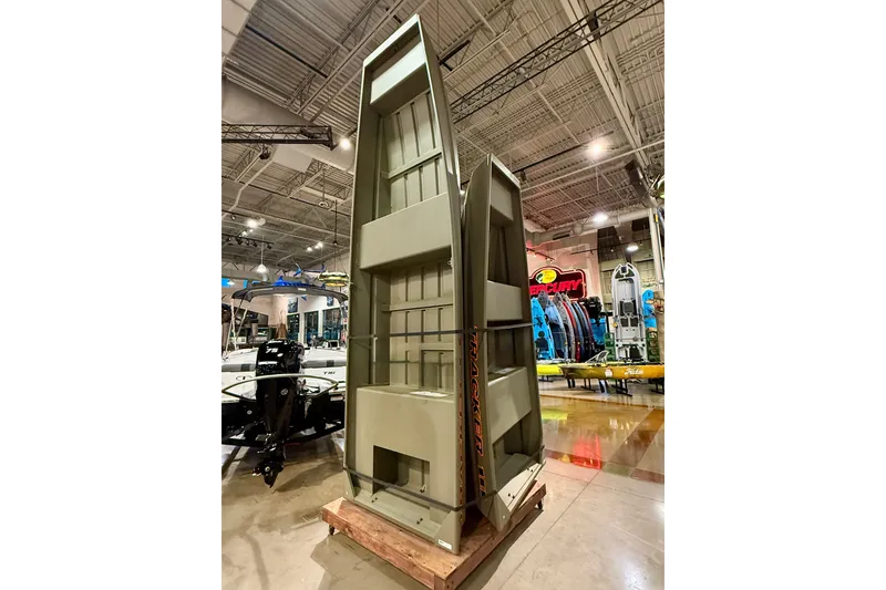The Image of 2026 Tracker Grizzly 14 Jon boat displayed vertically in a showroom. - 0