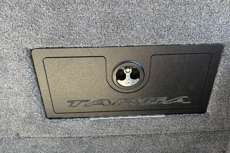 Slide: The Image of 2026 Tracker Targa V-18 WT boat compartment with secure latch and textured surface. - 54
