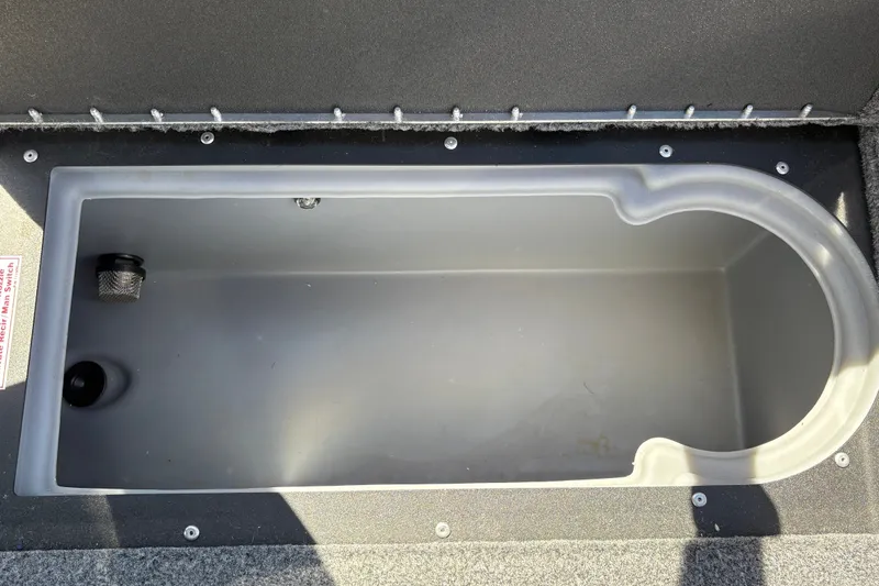 Slide: The Image of 2026 Tracker Targa V-18 WT boat storage compartment, empty and open. - 36