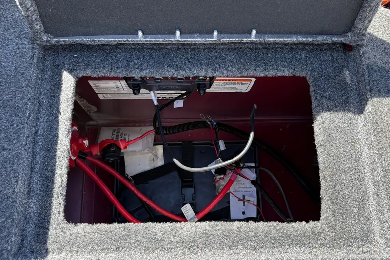 Slide: The Image of Battery compartment of 2026 Tracker Targa V-18 WT boat, featuring wiring and connections. - 48