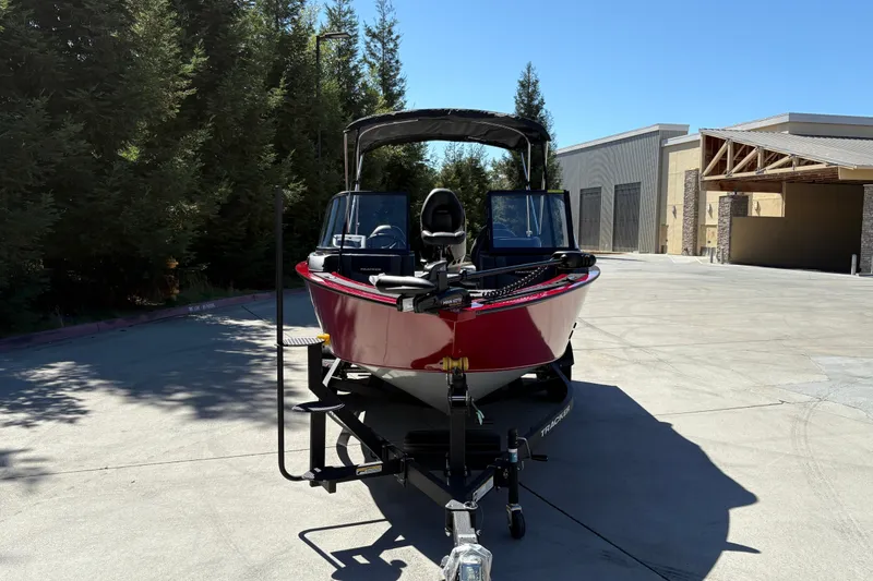 Slide: The Image of 2026 Tracker Targa V-18 WT boat on trailer, parked outdoors. - 13