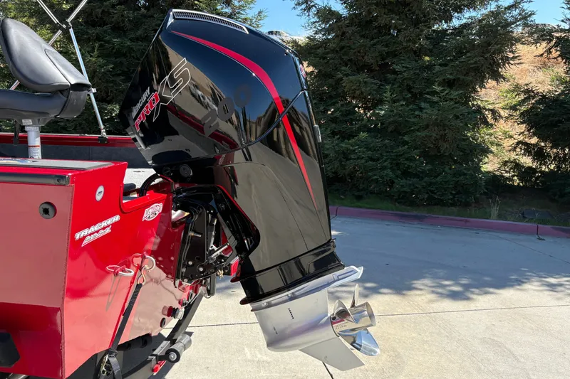 Slide: The Image of 2026 Tracker Targa V-18 WT boat with Mercury Pro XS engine, parked outdoors. - 10