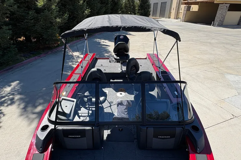 Slide: The Image of 2026 Tracker Targa V-18 WT boat with canopy, parked on concrete surface. - 15