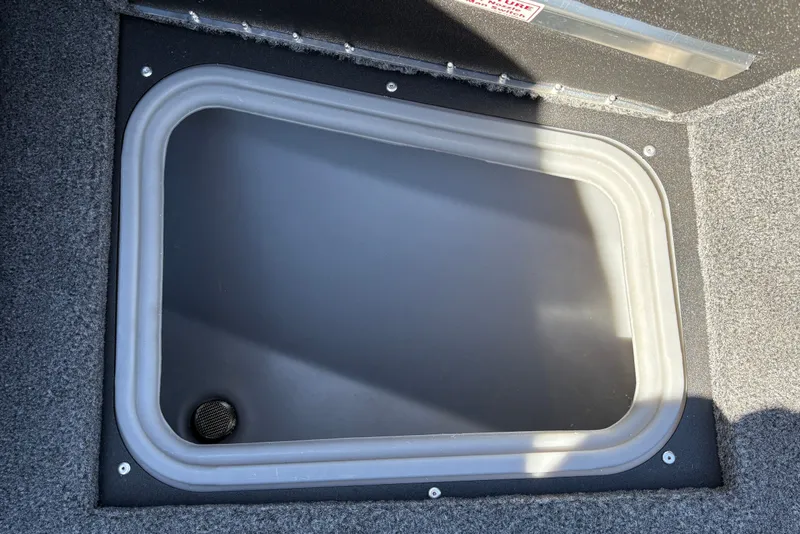 Slide: The Image of Storage compartment in 2026 Tracker Targa V-18 WT boat, featuring a secure lid. - 31