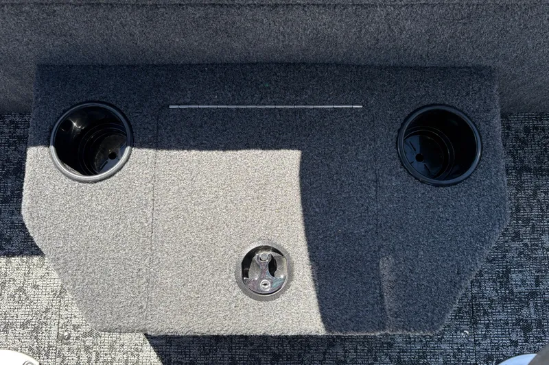 Slide: The Image of 2026 Tracker Targa V-18 WT boat interior with cup holders and carpeted surface. - 49