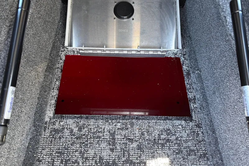 Slide: The Image of Interior view of 2026 Tracker Targa V-18 WT boat storage compartment with red panel. - 34