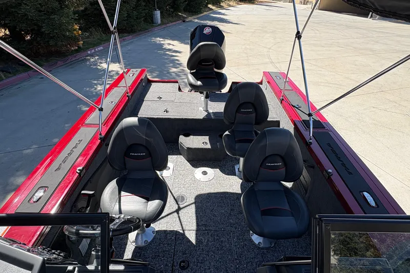 Slide: The Image of 2026 Tracker Targa V-18 WT boat interior with black seats and red accents. - 16