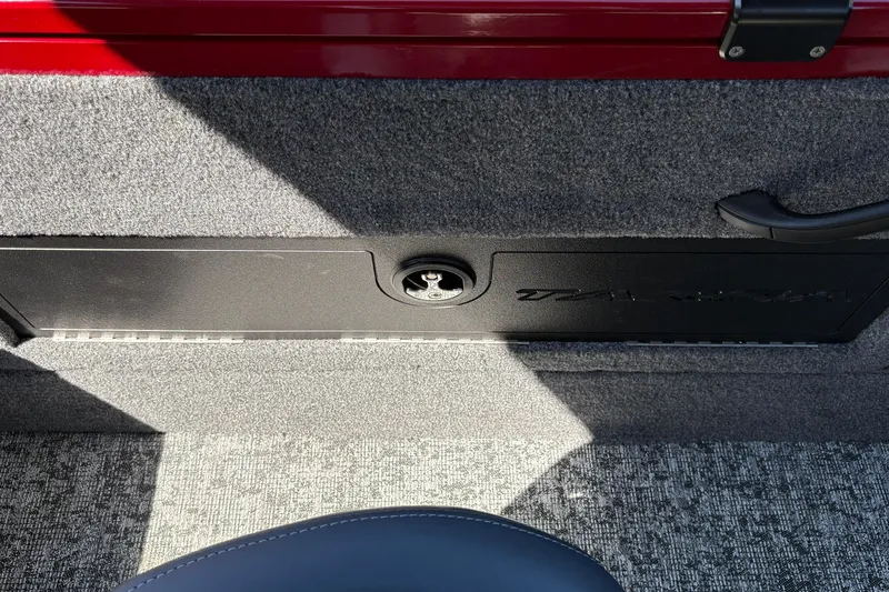 Slide: The Image of Interior of 2026 Tracker Targa V-18 WT boat with carpeted flooring and storage compartment. - 35